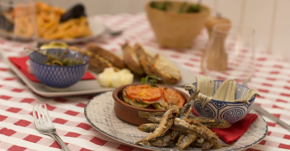 from australia to spain for the love of food red and white tablecloth with rustic spanish dishes
