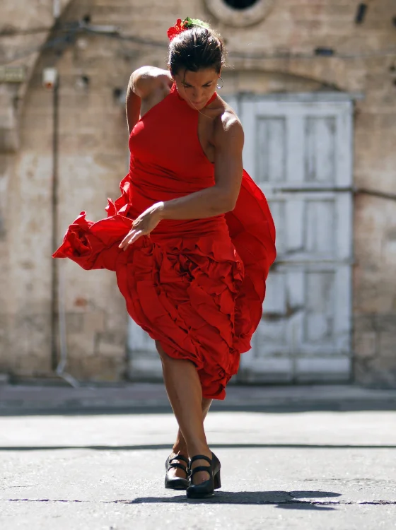 flamenco dancer on the streets of spain in a red dress