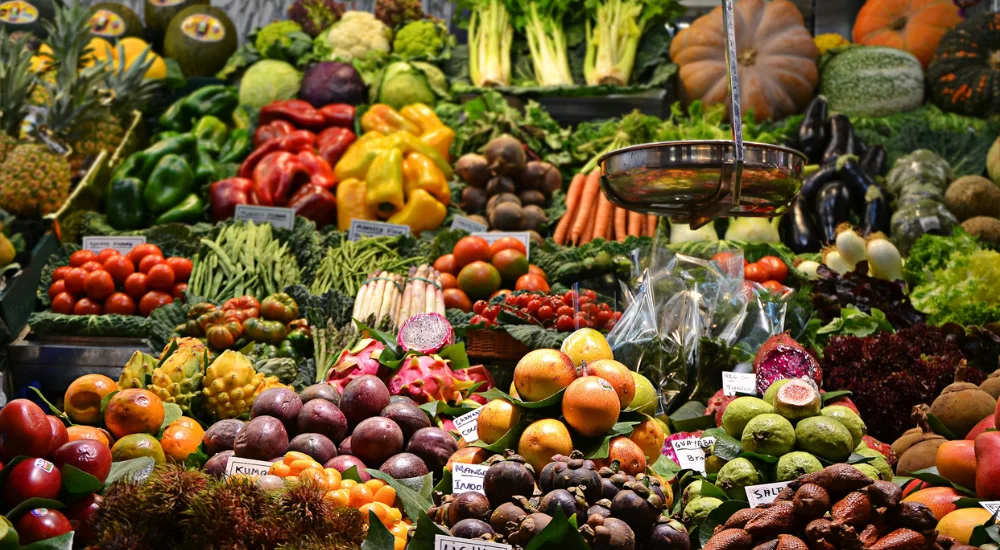 array of fresh vegetables and fruit at a market in barcelona