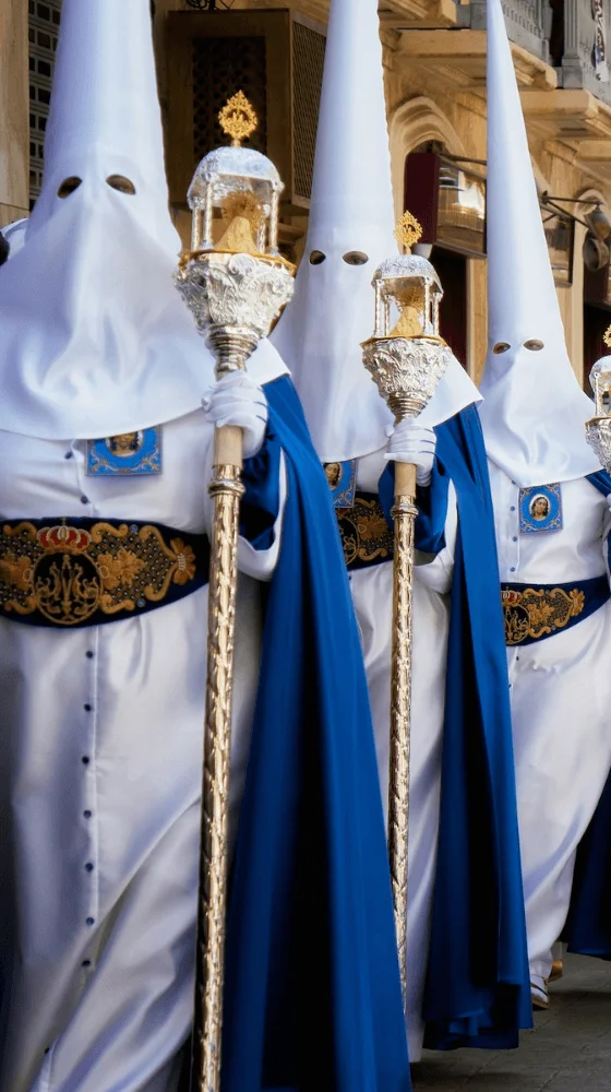 procession at semana santa wearing white robes and masks