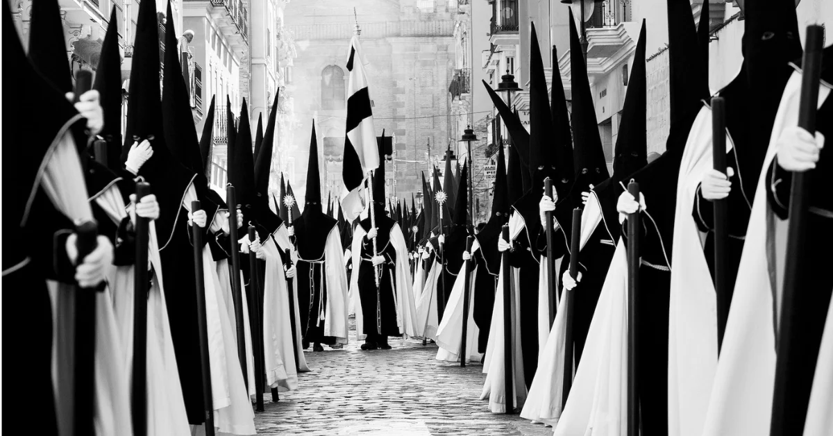 semana-santa-compressed semana santa black and white image of procession in white robes and black masks