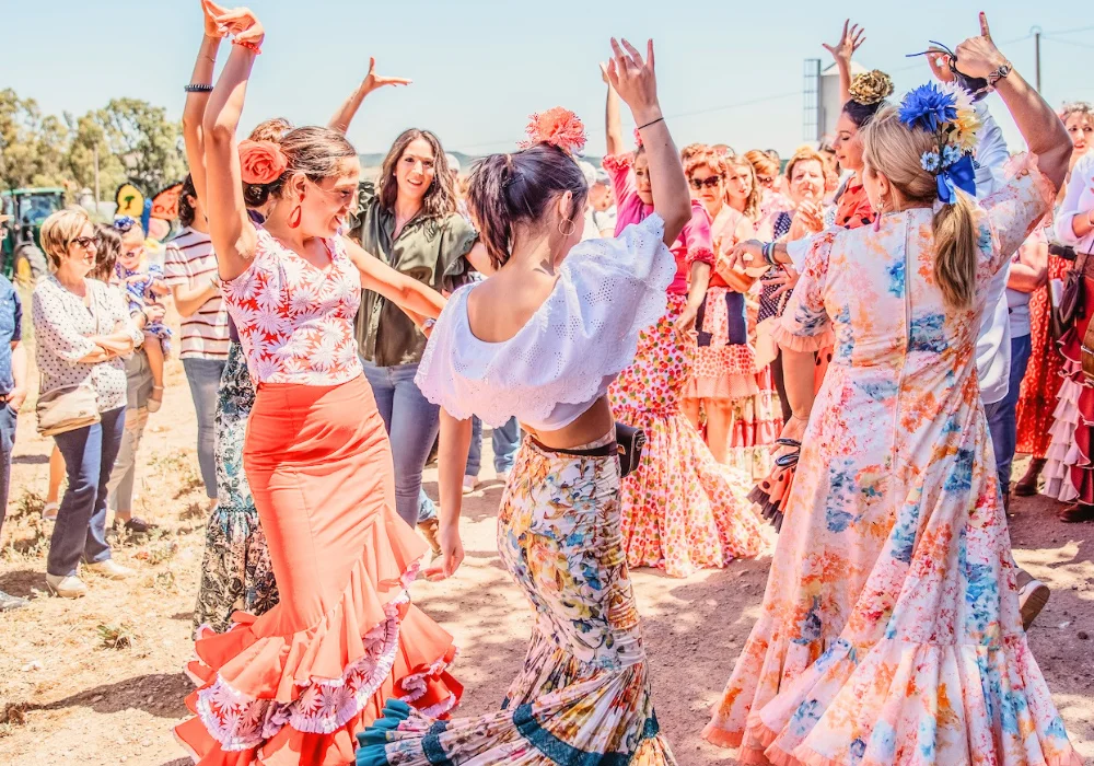 women wearing traditional spanish dress dancing in a village setting