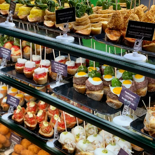 spanish tapas on display in a deli cabinet