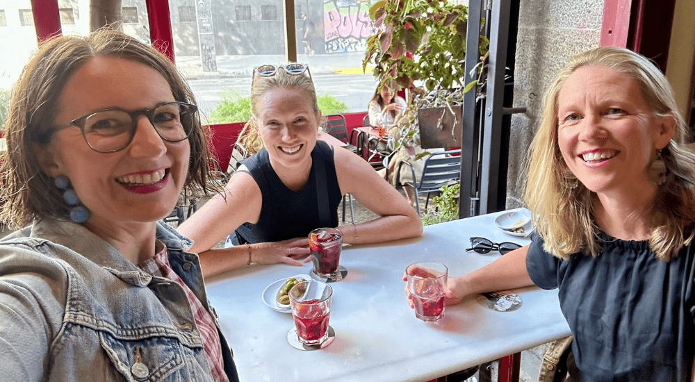 three friends enjoying a glass of vermut in spain